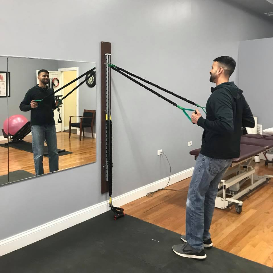 Physical therapist performing manual shoulder therapy on patient in Chicago clinic