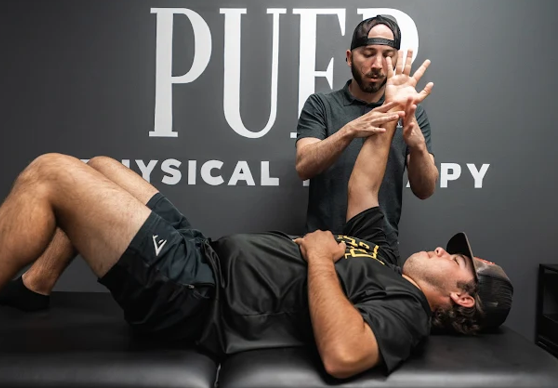 Patient working one-on-one with a physical therapist during a post-surgical rehabilitation session